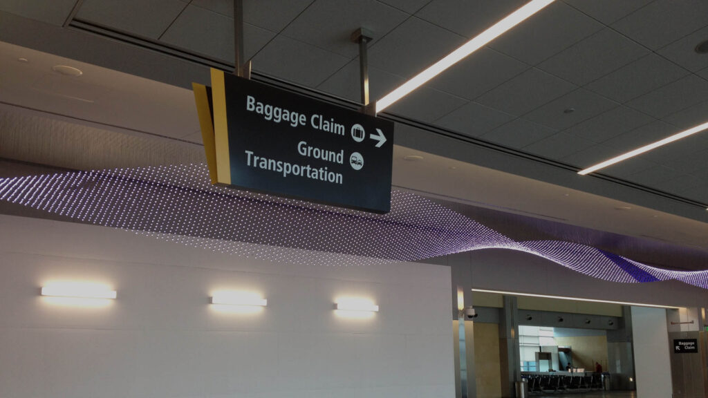 San Diego International Airport signage with directions to Baggage Claim and Ground Transportation