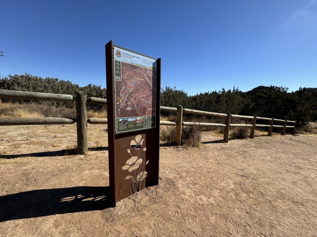 Corten steel map kiosk with custom cut flora and fauna and colorful visitor-centric map